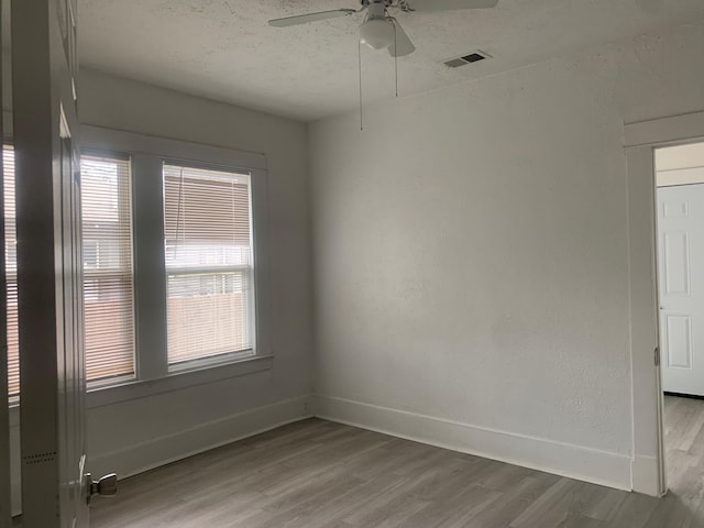 empty room with hardwood / wood-style flooring and ceiling fan