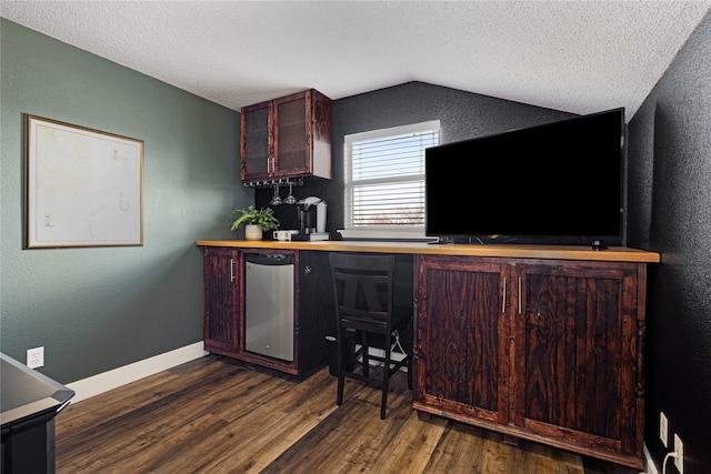 kitchen featuring a textured ceiling, dark hardwood / wood-style flooring, fridge, and lofted ceiling