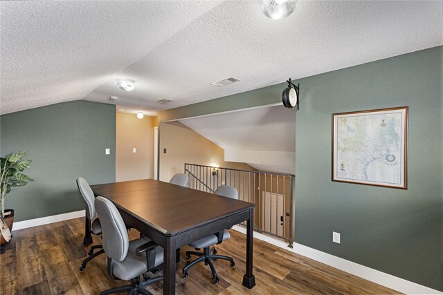 office with dark hardwood / wood-style flooring, a textured ceiling, and vaulted ceiling