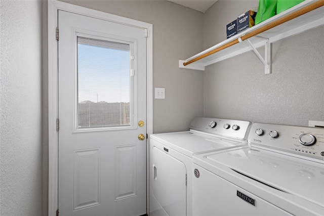 clothes washing area featuring washer and clothes dryer