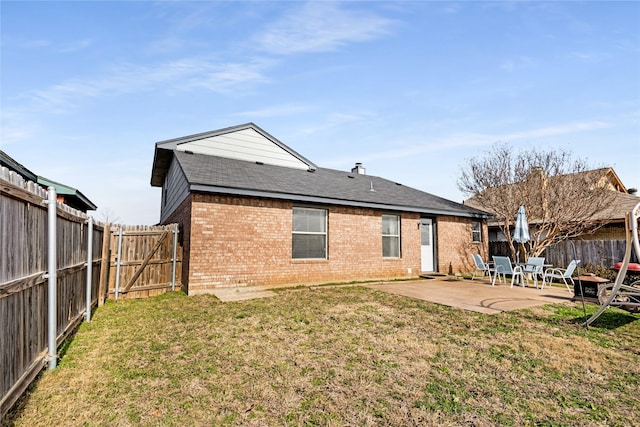 rear view of property with a patio and a yard