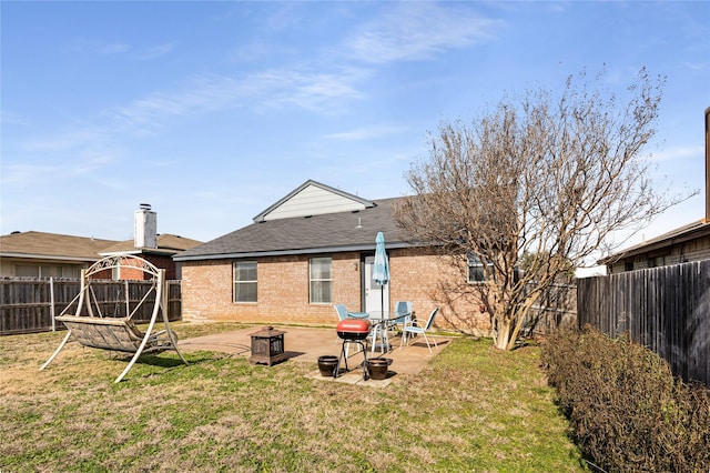 rear view of property featuring a lawn, a fire pit, a patio, and a gazebo