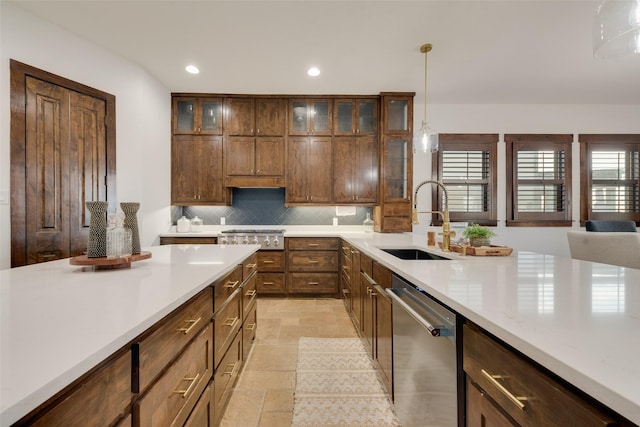 kitchen featuring sink, dishwasher, hanging light fixtures, and decorative backsplash