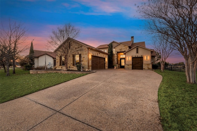 view of front of property with a yard and a garage