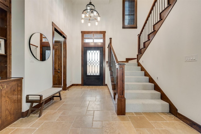 foyer entrance featuring a high ceiling and a chandelier