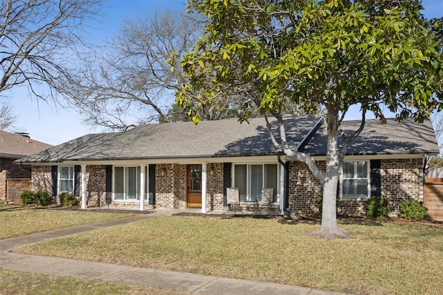 ranch-style home featuring a porch and a front yard