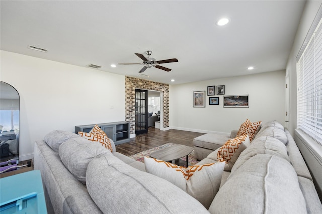 living room featuring ceiling fan and wood-type flooring