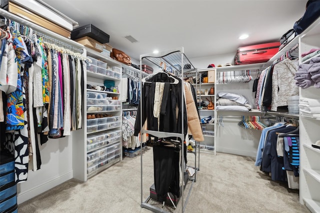 spacious closet featuring light carpet