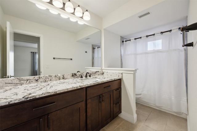 full bathroom featuring tile patterned floors, toilet, vanity, and shower / bath combo