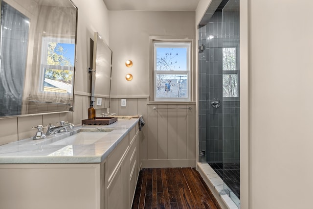 bathroom with walk in shower, hardwood / wood-style floors, a wealth of natural light, and vanity