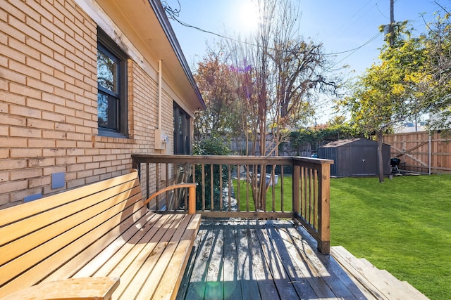 wooden deck with a lawn and a shed