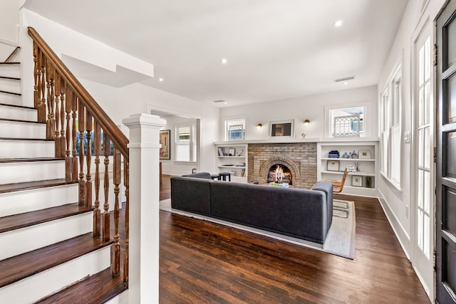 living room with a fireplace and dark hardwood / wood-style floors