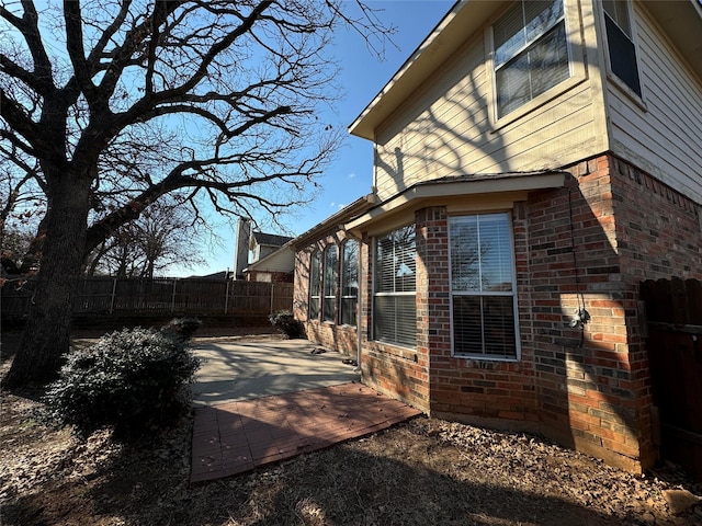 view of side of home featuring a patio