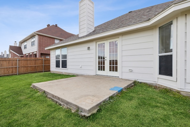 back of house featuring french doors, a patio area, and a yard