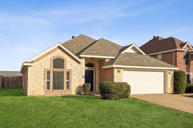 view of front of home with a front yard and a garage