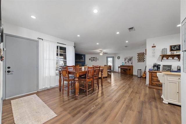 dining space featuring ceiling fan and dark hardwood / wood-style flooring