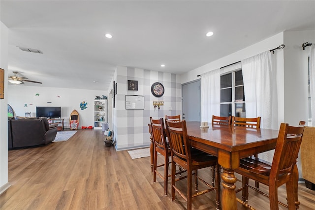 dining space featuring light wood-type flooring and ceiling fan