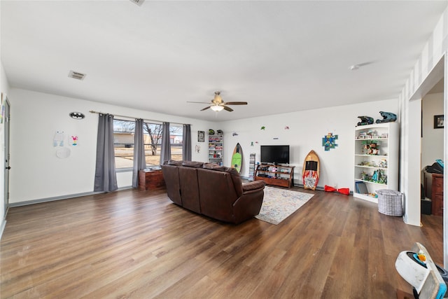 living room featuring ceiling fan and wood-type flooring