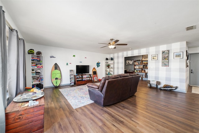 living room featuring ceiling fan and dark hardwood / wood-style floors