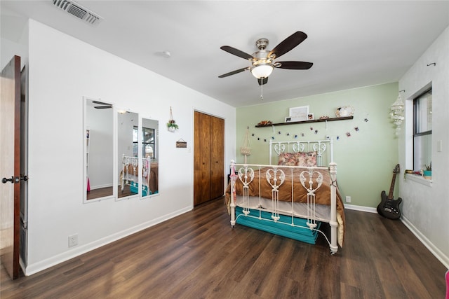 bedroom featuring ceiling fan and dark wood-type flooring