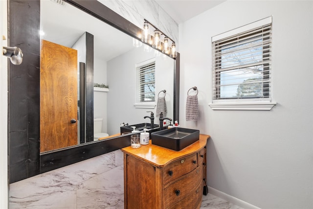 bathroom featuring toilet and vanity