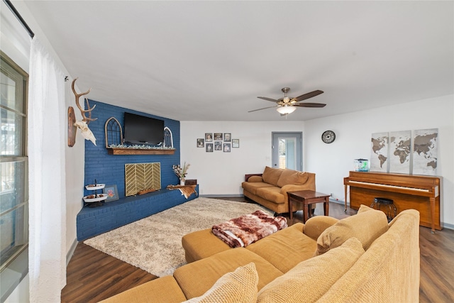 living room with a fireplace, hardwood / wood-style floors, and ceiling fan