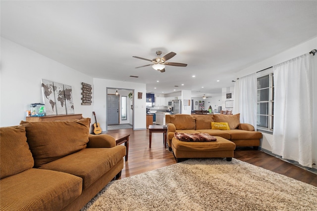 living room featuring hardwood / wood-style floors and ceiling fan