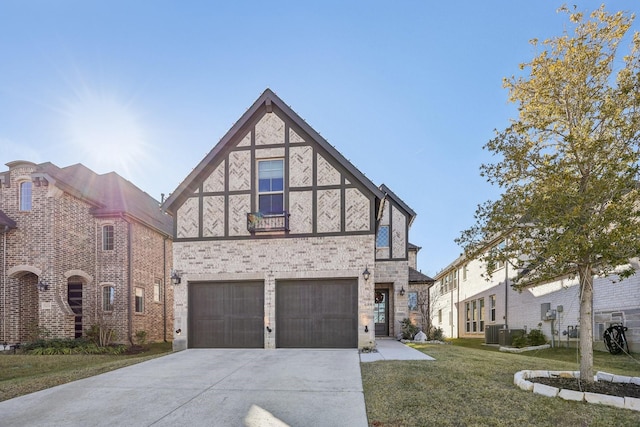 english style home featuring central AC, a front yard, and a garage