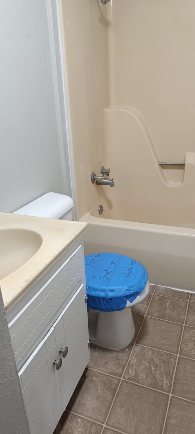 bathroom featuring tile patterned floors,  shower combination, and vanity