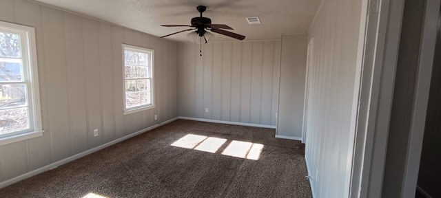 carpeted empty room featuring a textured ceiling and ceiling fan