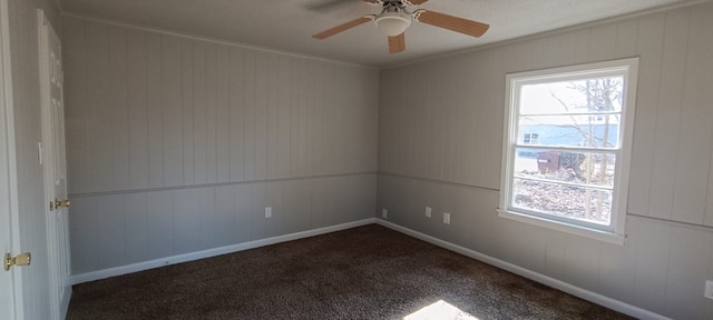 carpeted spare room featuring ceiling fan and ornamental molding