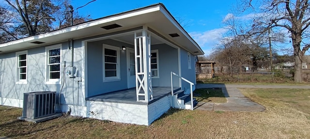 view of property exterior with a lawn and central AC unit