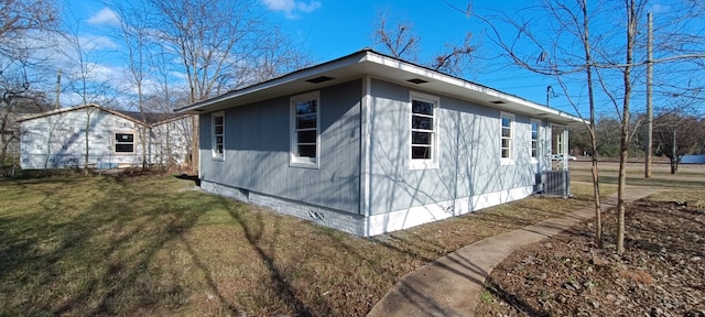 view of home's exterior with central AC and a lawn