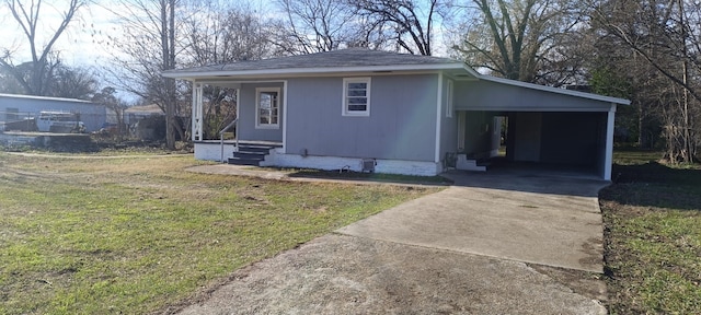 view of front of property with a front yard and a carport