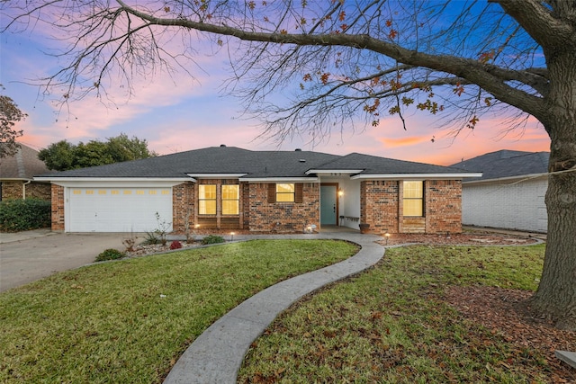 ranch-style home with a lawn and a garage