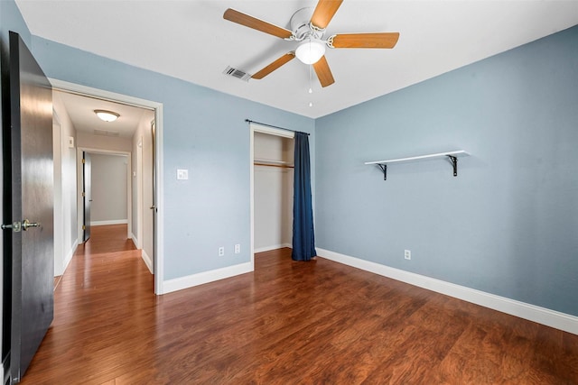 unfurnished bedroom featuring ceiling fan, a closet, and wood-type flooring