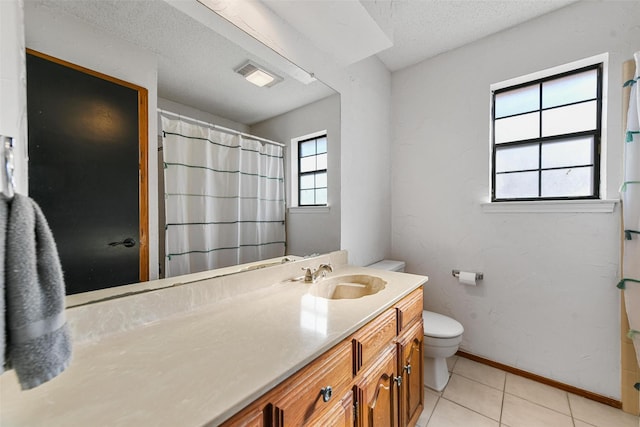 bathroom featuring toilet, tile patterned flooring, a textured ceiling, and vanity