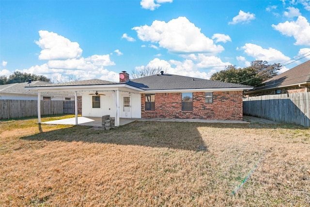 rear view of house featuring a patio area and a yard