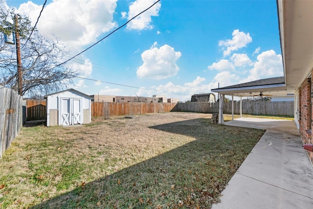 view of yard featuring a storage unit and a patio area