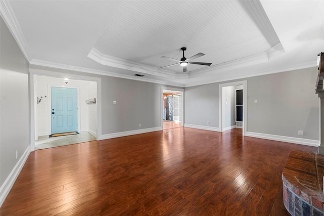 unfurnished room with ceiling fan, crown molding, hardwood / wood-style flooring, and a tray ceiling