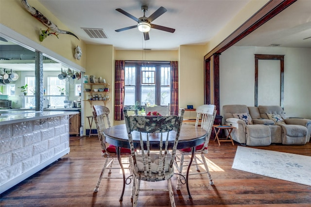 dining area featuring dark hardwood / wood-style flooring and ceiling fan