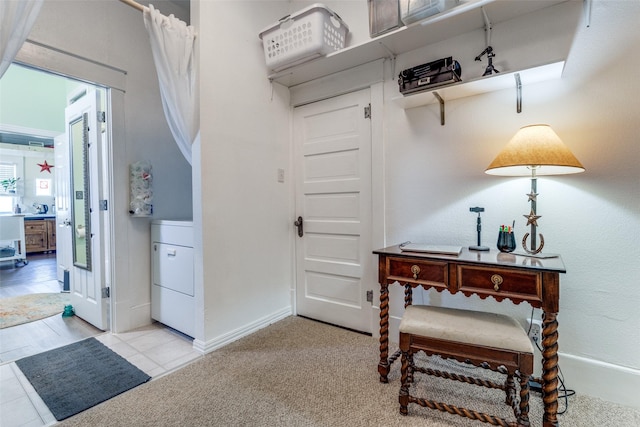 interior space featuring washer / dryer and light carpet