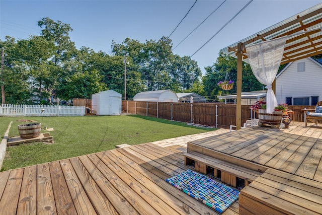 wooden terrace featuring a yard and a shed