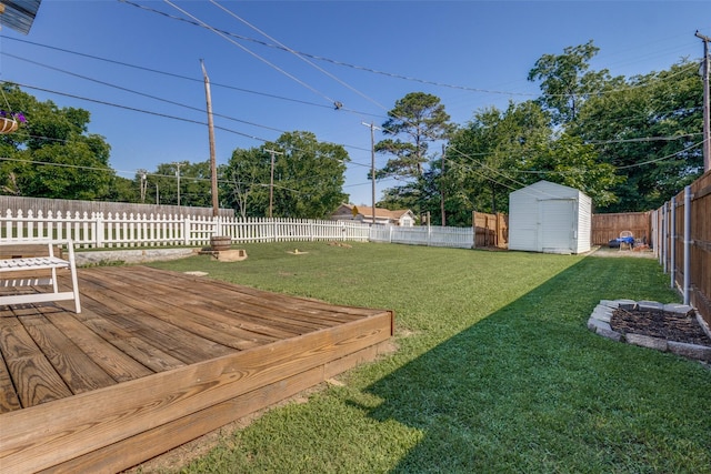 view of yard featuring a storage unit and a wooden deck