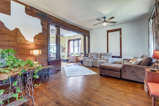 living room with ceiling fan and hardwood / wood-style flooring