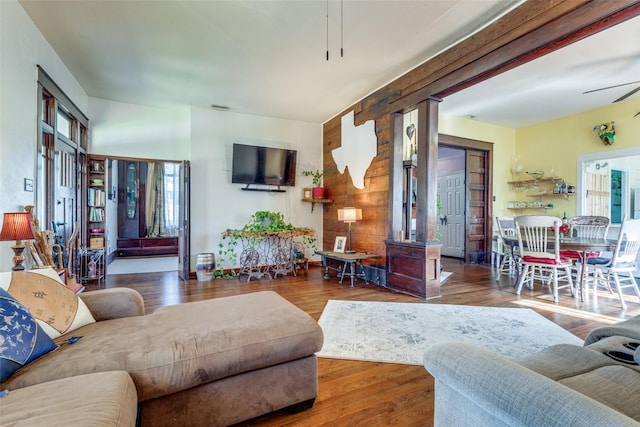 living room with ceiling fan and hardwood / wood-style floors