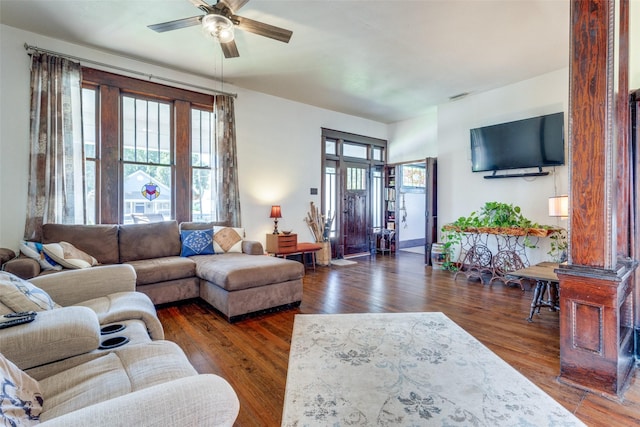 living room featuring ceiling fan, a wealth of natural light, and dark hardwood / wood-style floors