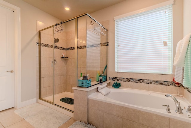 bathroom with tile patterned floors and plus walk in shower