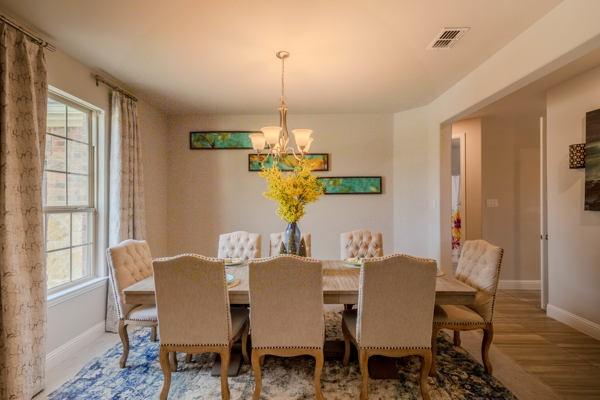 dining room featuring a healthy amount of sunlight and a notable chandelier