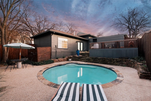 pool at dusk with a patio